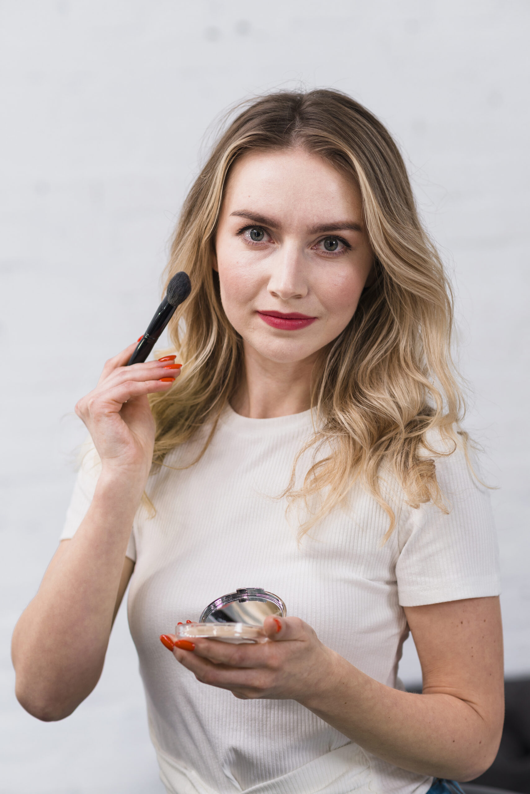 female-visagiste-posing-camera-with-cosmetics-scaled.jpg