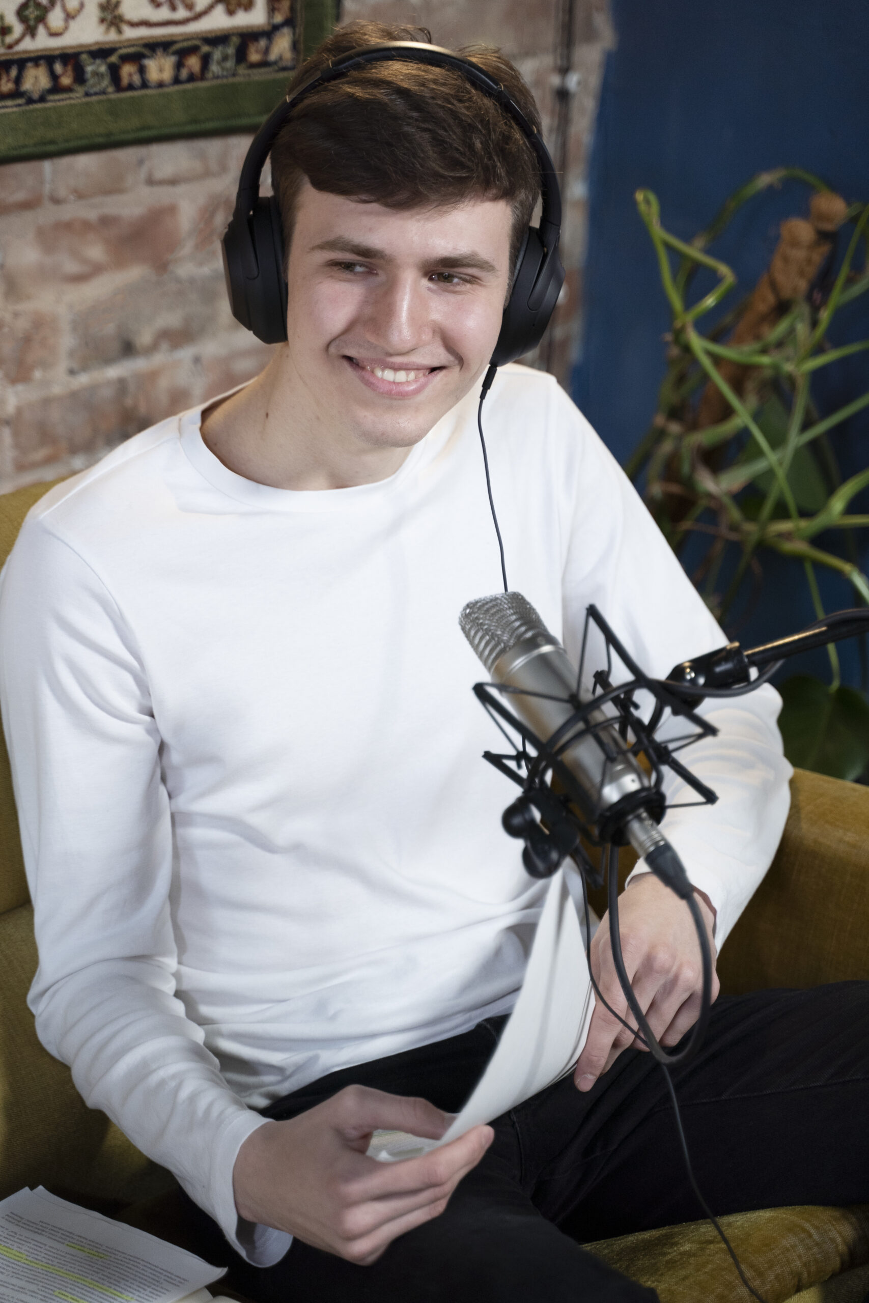 man-with-microphone-headphones-running-podcast-studio-scaled.jpg